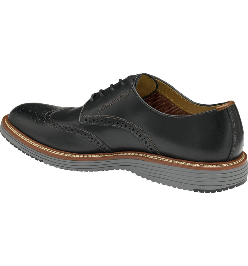 Johnston & Murphy Upton Wingtip shoes in black leather with brogue detailing and stitched welt, side angled view.