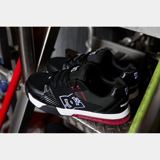 DC WorkCrew Versatile Work Comp Toe shoes in black with white accents, red cushioning detail, and composite toe protection, side angle view.