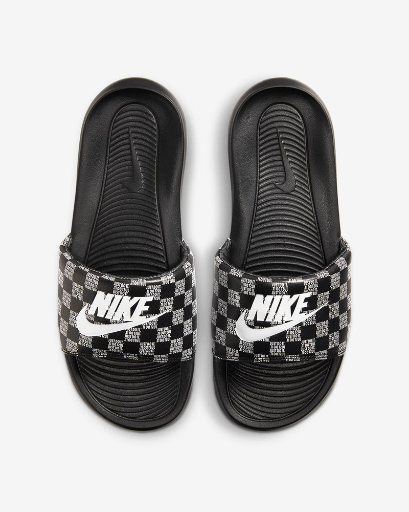Nike Victori One Printed slides in black with checkered pattern strap featuring "Just Do It" text and white Nike logo, top view.