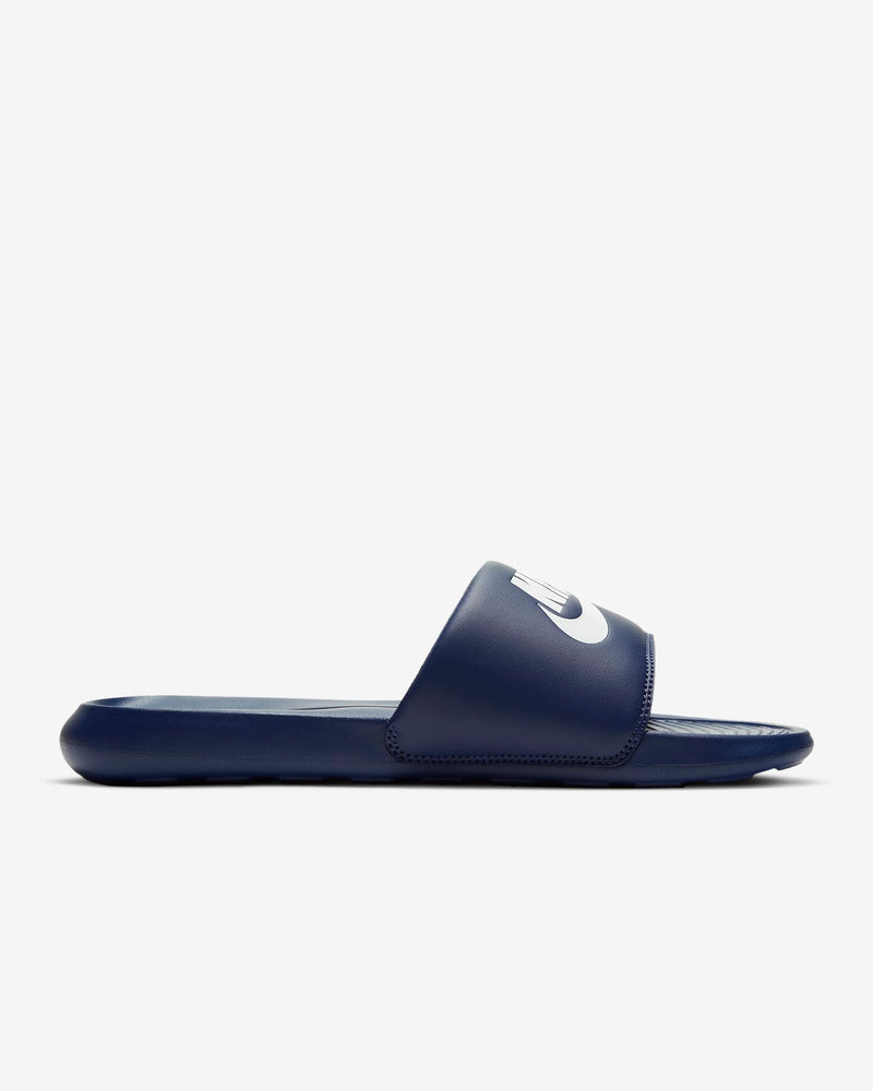 Navy slide sandal with a brand logo on a light gray background