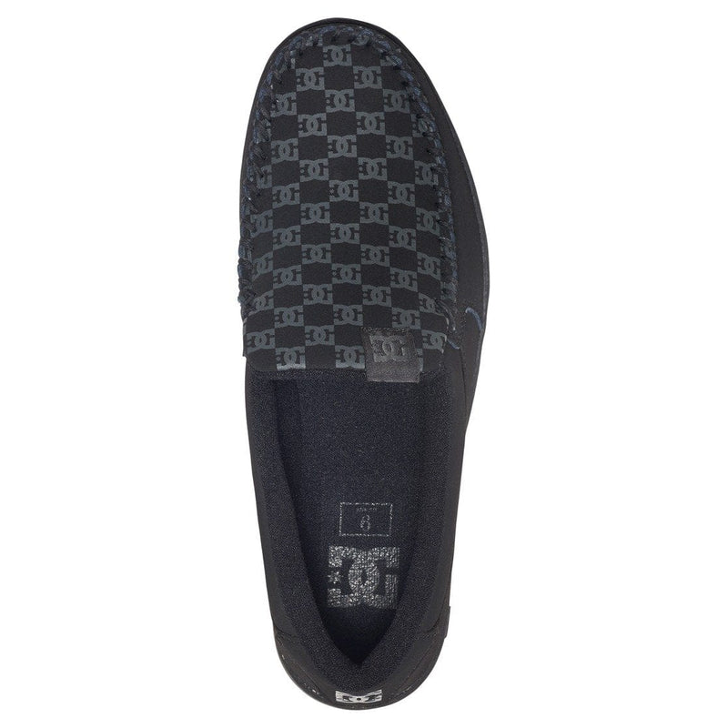 DC Footwear Villain 2 slip-on shoes with black and gray logo pattern on canvas upper, top view showing moccasin-style stitching.