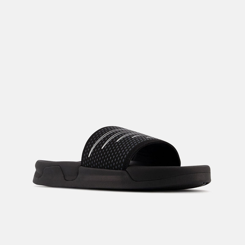 New Balance Zare Comfort slides in black with textured strap and cushioned sole, angled side view.